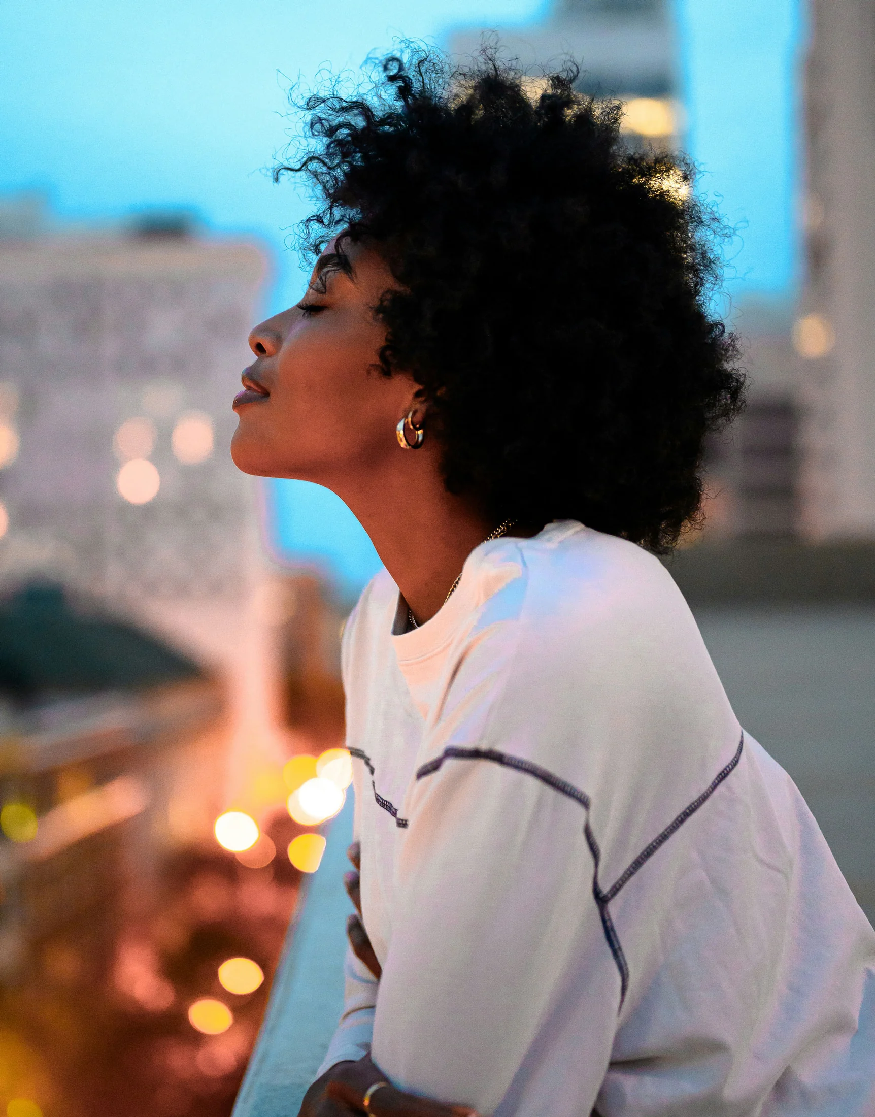 Woman with natural hair overlooking the city